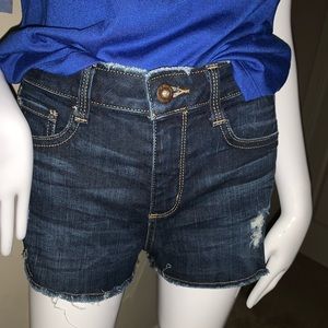 A pair of two blue jean shorts